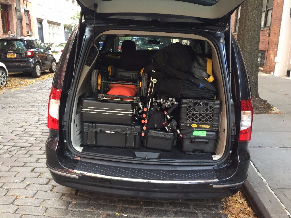 Production crew loading trunk including Canon C300 Mark II camera